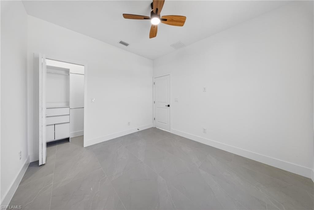 Unfurnished bedroom featuring baseboards and ceiling fan