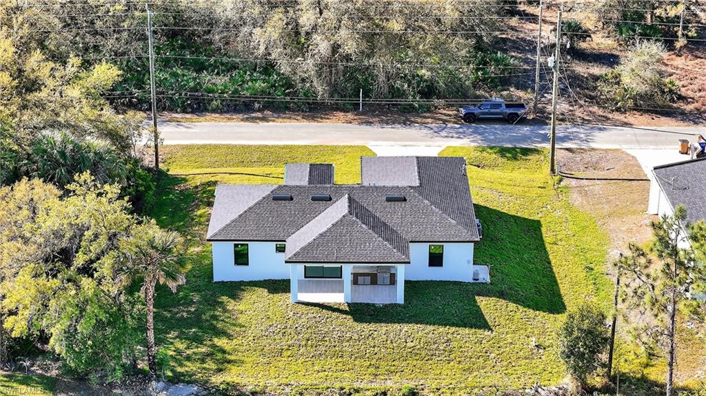 View from above of property with a tree filled landscape
