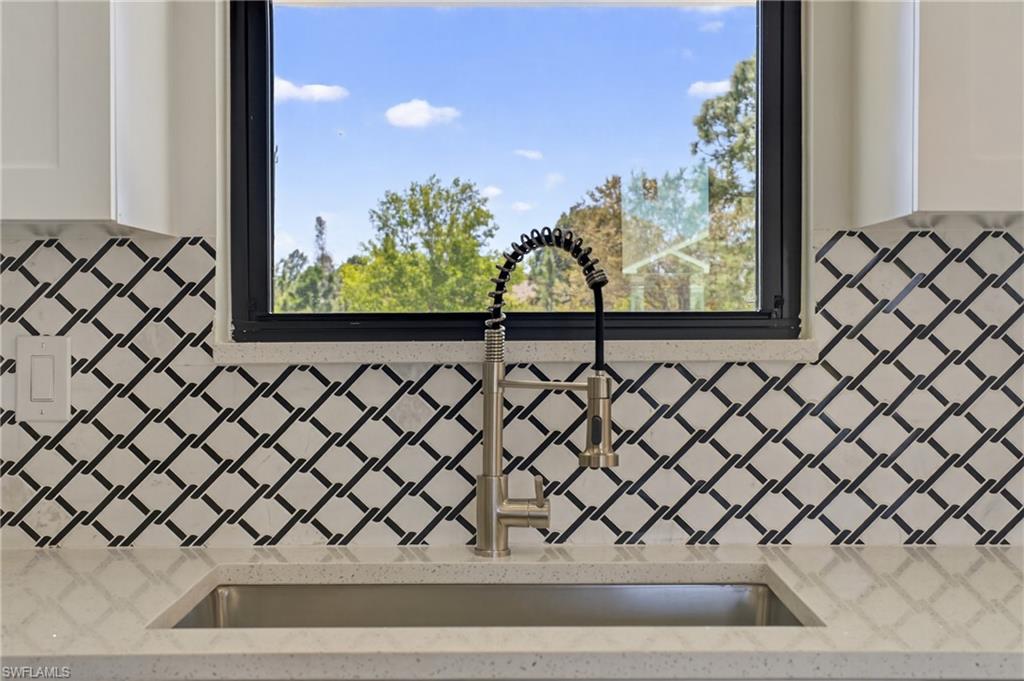 Kitchen view of light stone countertops and white cabinets