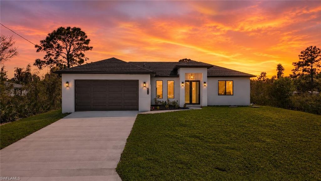 Contemporary single-story residence with a dark brown garage door and matching roofline