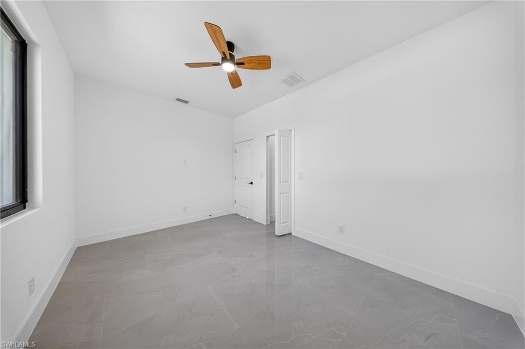 Unfurnished bedroom featuring ceiling fan and baseboards