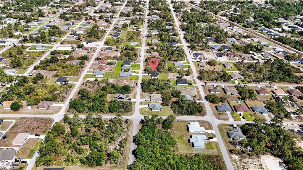 Aerial view of property's location with nearby suburban area