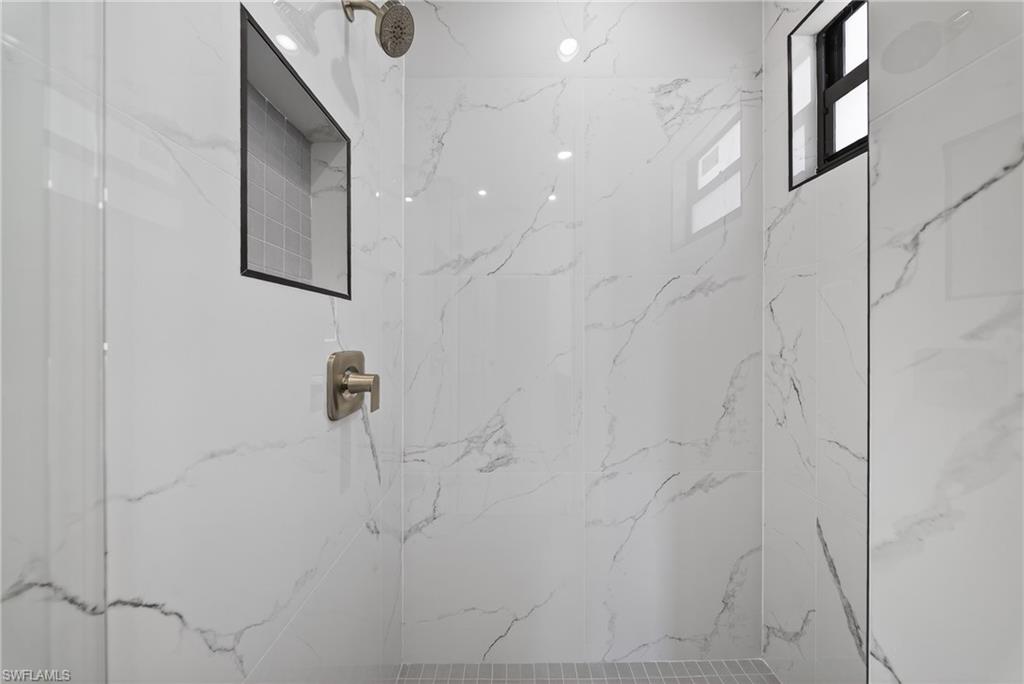 Bathroom featuring a marble finish shower