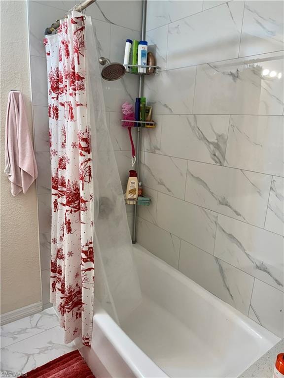 Full bathroom with shower / bathtub combination with curtain, a textured wall, and marble look tile flooring