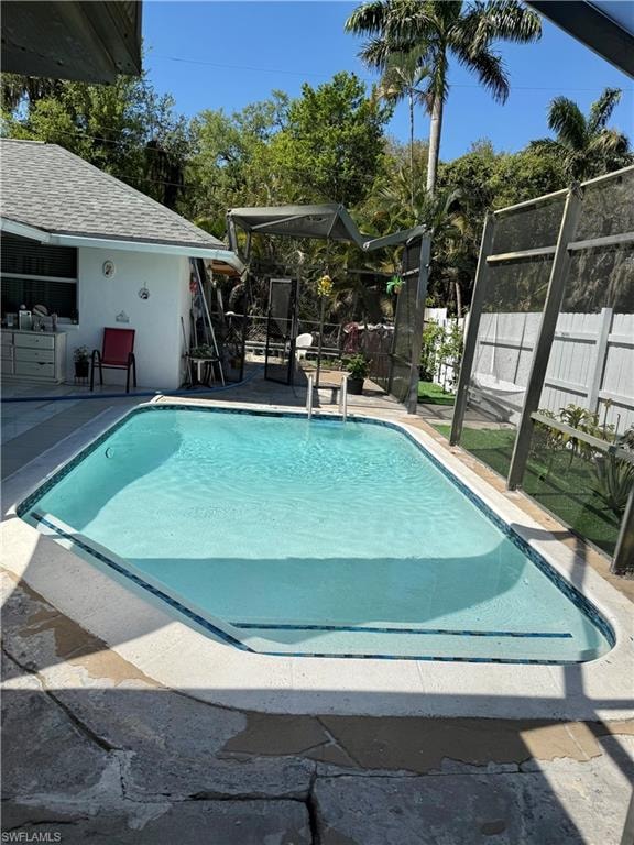 View of swimming pool featuring patio surround