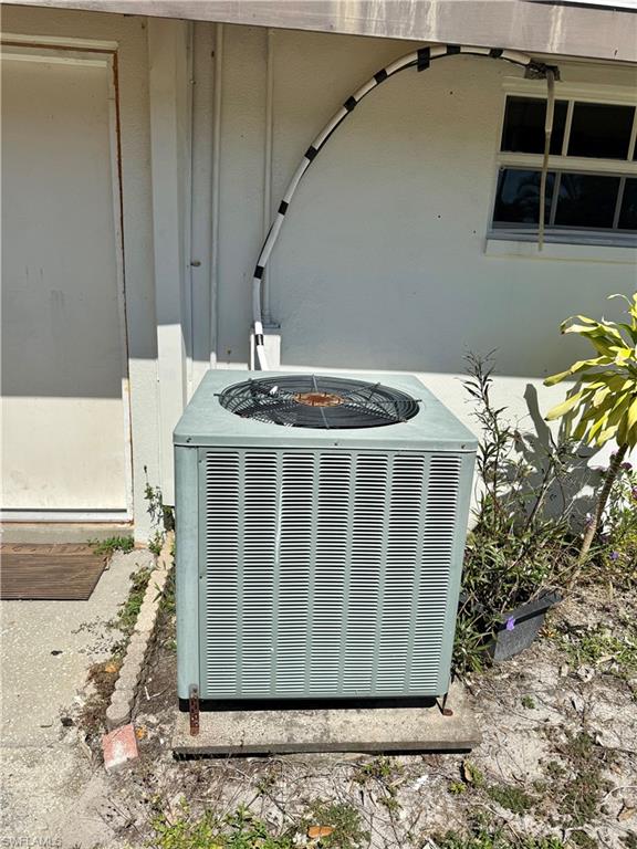 Exterior view of a central AC unit and a fire pit