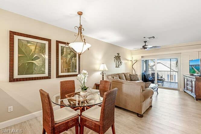 Dining area with light wood-type flooring and a ceiling fan