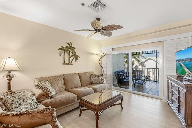 Living room featuring ceiling fan and wood finished floors