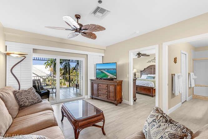 Living room with a ceiling fan and light wood finished floors