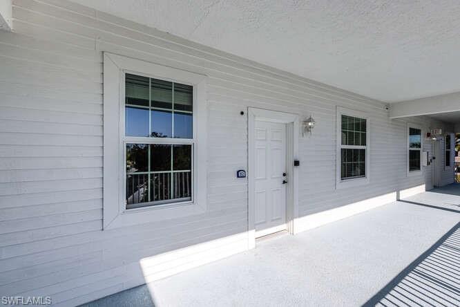 View of exterior entry featuring a patio