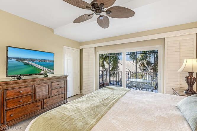 Bedroom with access to outside, ceiling fan, and light colored carpet