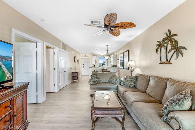 Living area with a ceiling fan and light wood-type flooring