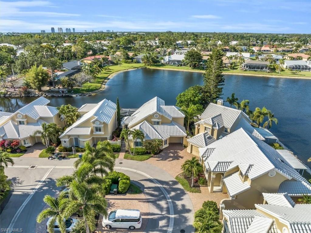 Aerial perspective of suburban area featuring a nearby body of water