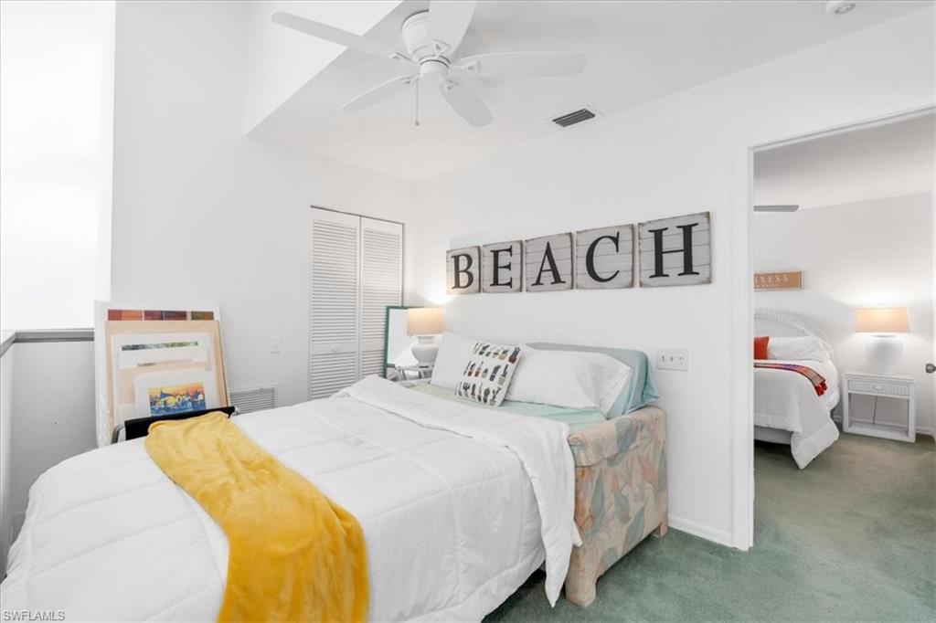 Carpeted bedroom with a closet and ceiling fan