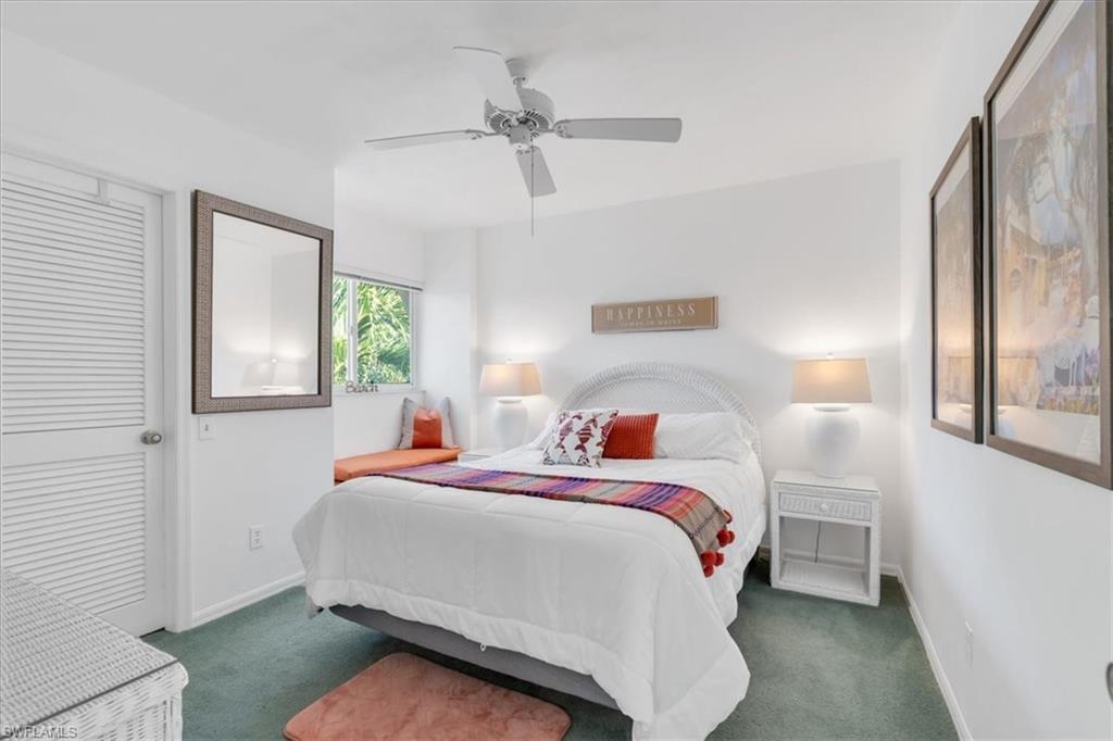 Bedroom with ceiling fan and carpet