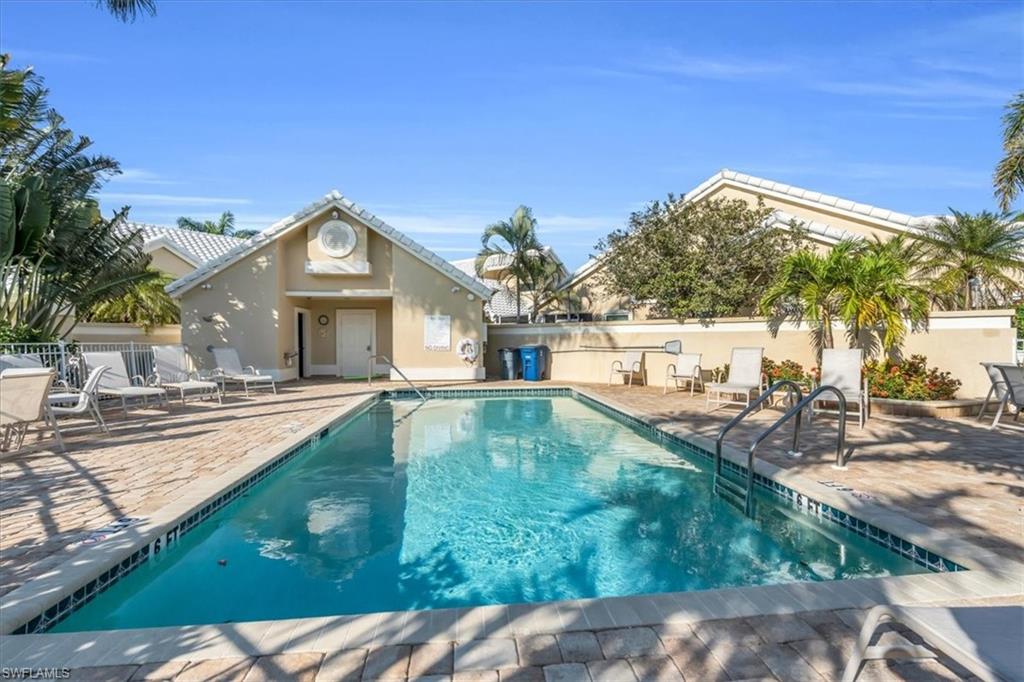 Community pool with a patio
