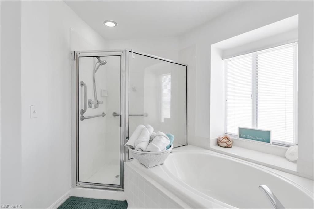 Full bathroom with a stall shower and a bath