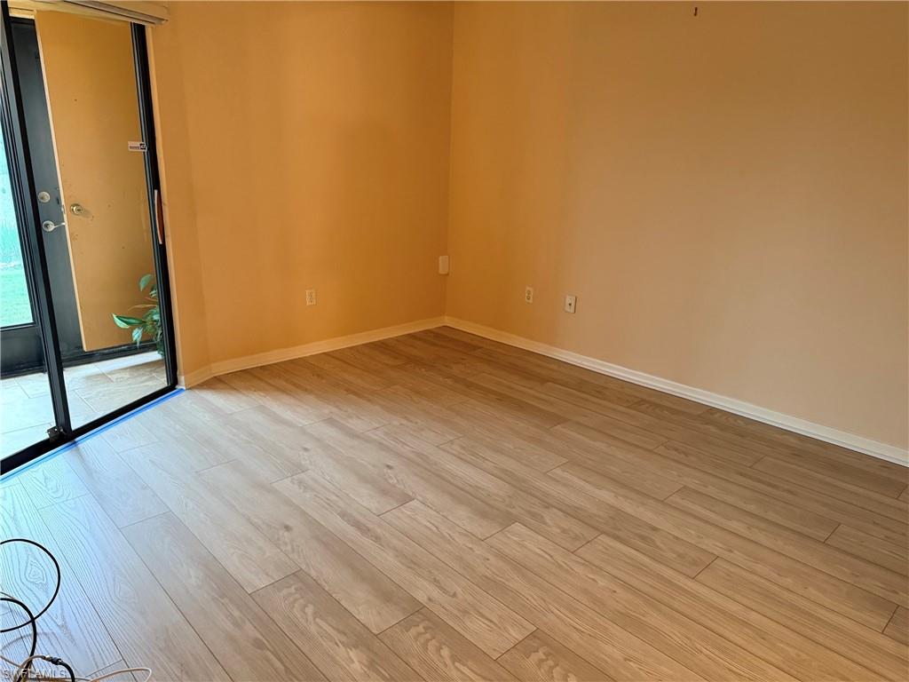 Wood-finish flooring, neutral wall tones, and a sliding glass door