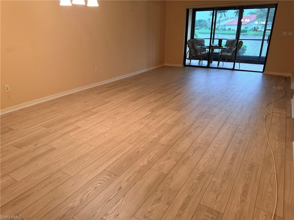 Wood-finish flooring, neutral wall tones, and overhead lighting