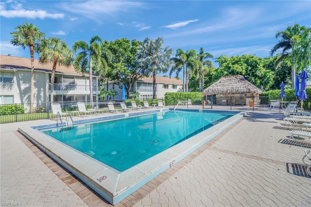 Community pool with a patio area and a gazebo