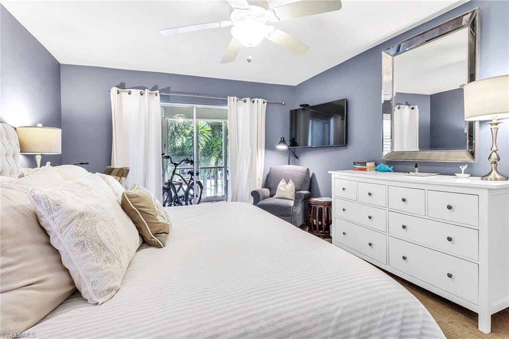 Bedroom featuring access to outside, a ceiling fan, and dark carpet