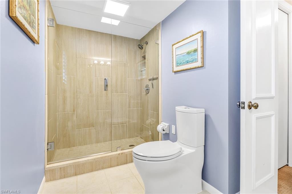 Full bath with a stall shower and light tile patterned floors