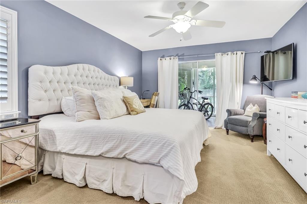 Bedroom featuring light carpet, access to exterior, and a ceiling fan
