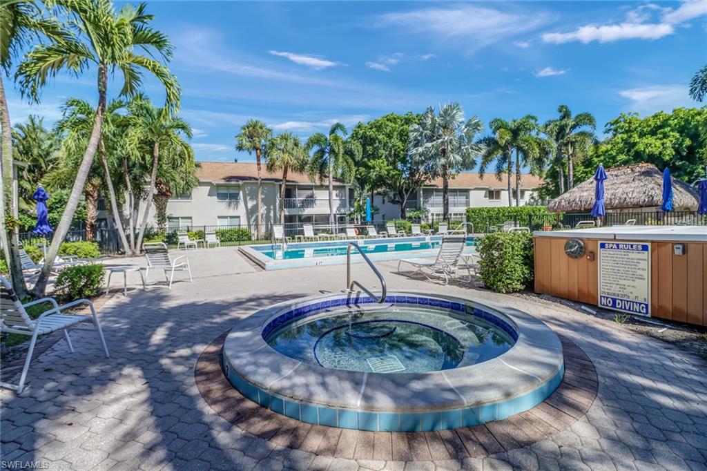 Community pool with a community hot tub and a patio area