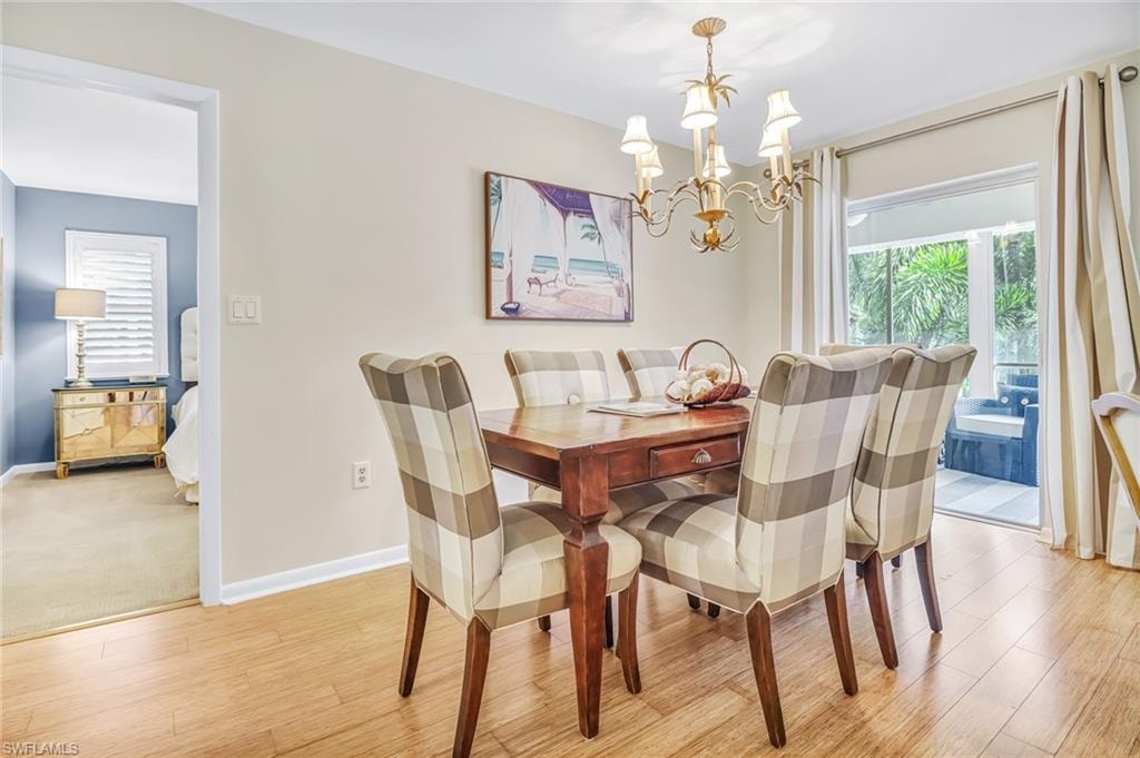 Dining room with suspended lighting and light wood-style floors