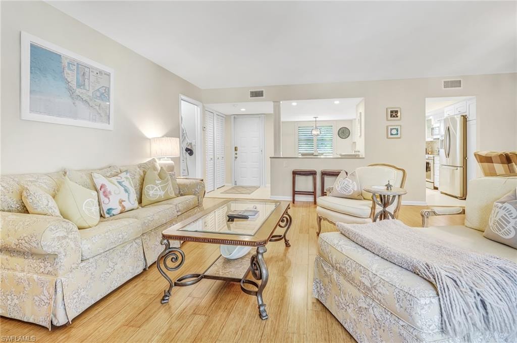Living room featuring light wood-type flooring and baseboards