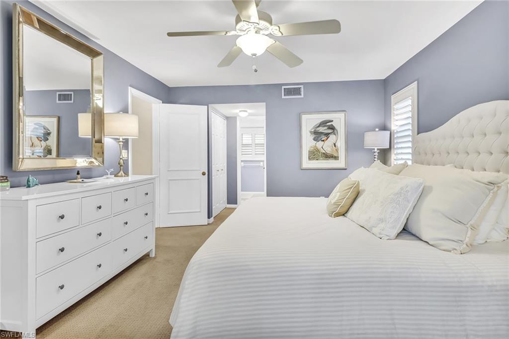 Bedroom with light colored carpet and ceiling fan