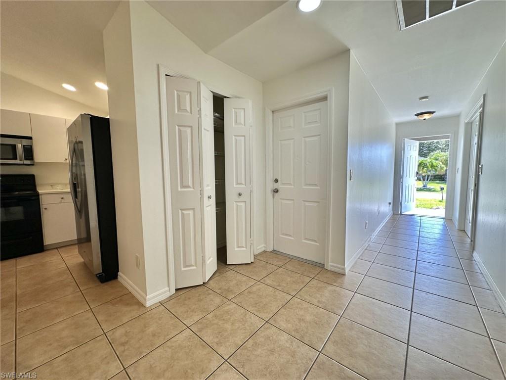 4317 View toward front entryway, double pantry and doorway to one car garage.
