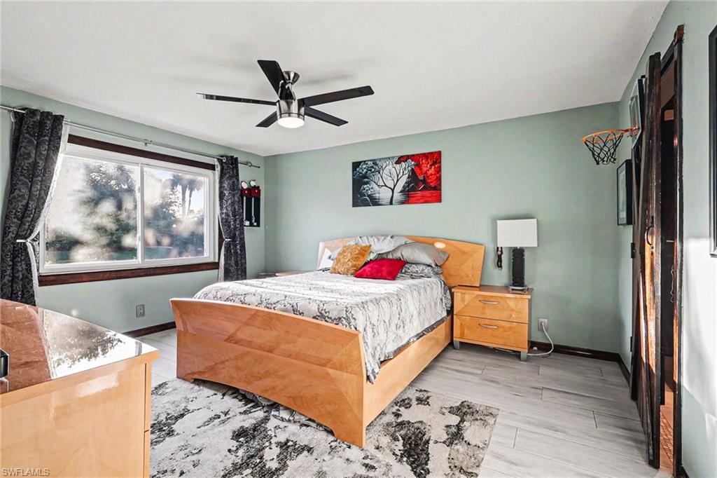 Bedroom with ceiling fan and light wood finished floors