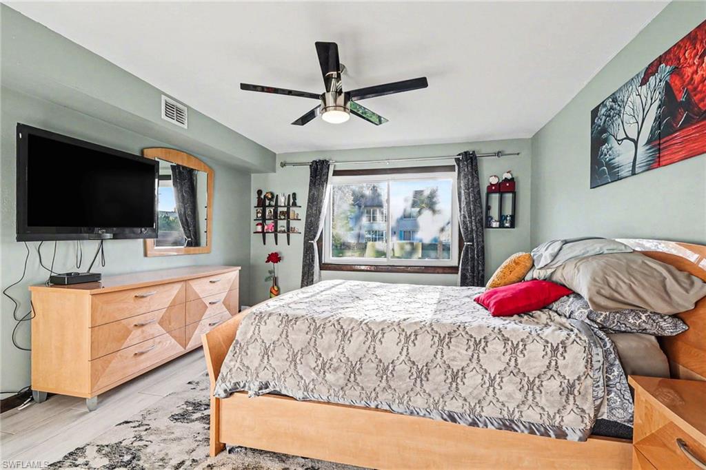Bedroom with ceiling fan and light wood-style floors