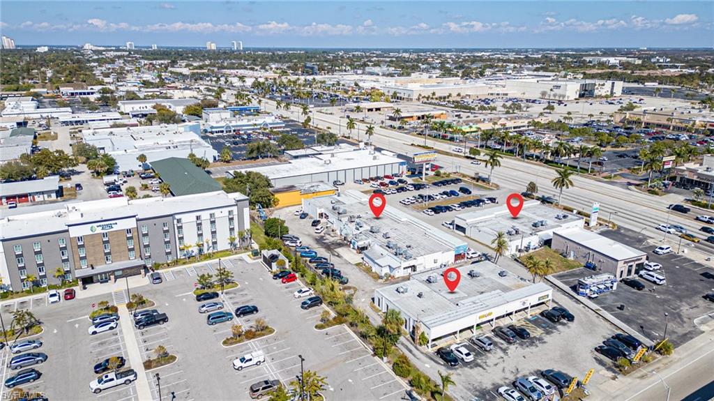 Aerial view of property's location featuring a commercial area