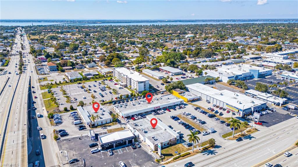 Aerial view of property's location with a commercial area