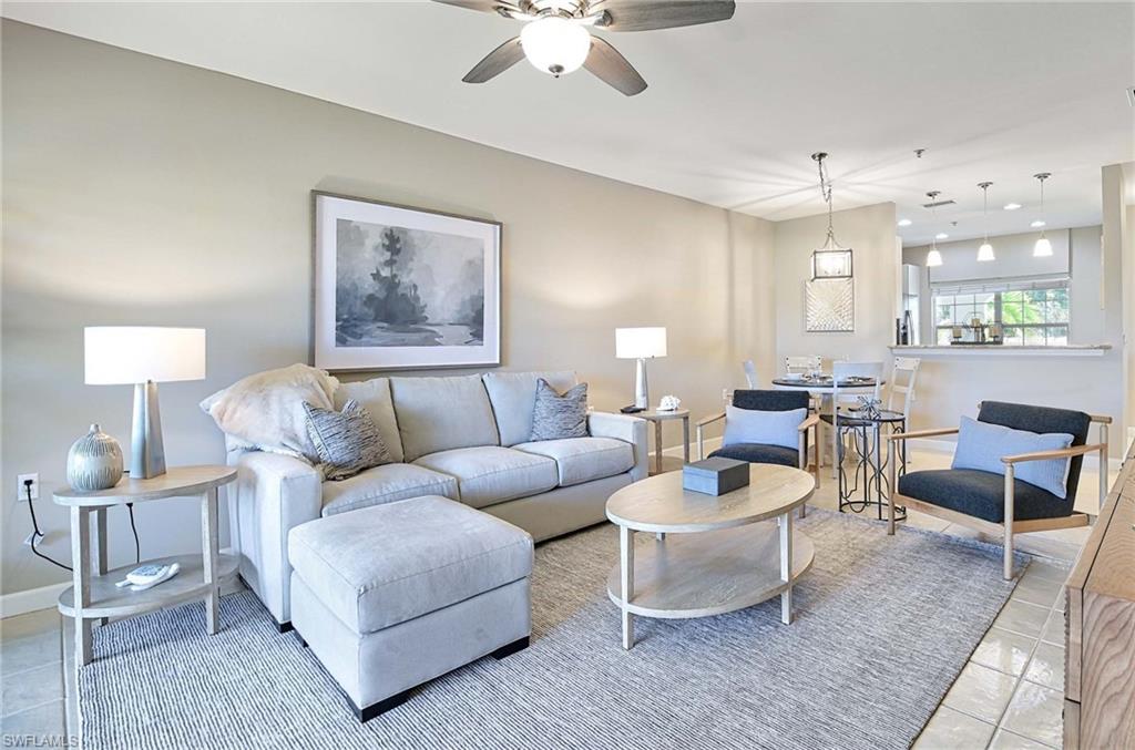 Living room with light tile patterned flooring and a ceiling fan