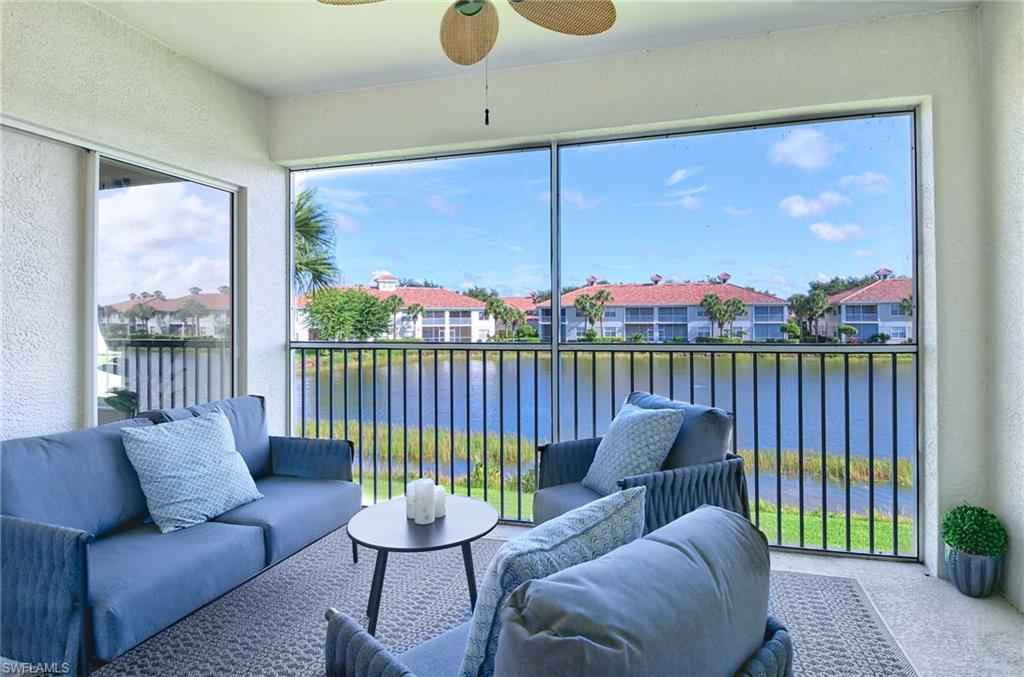 Sunroom featuring a water view