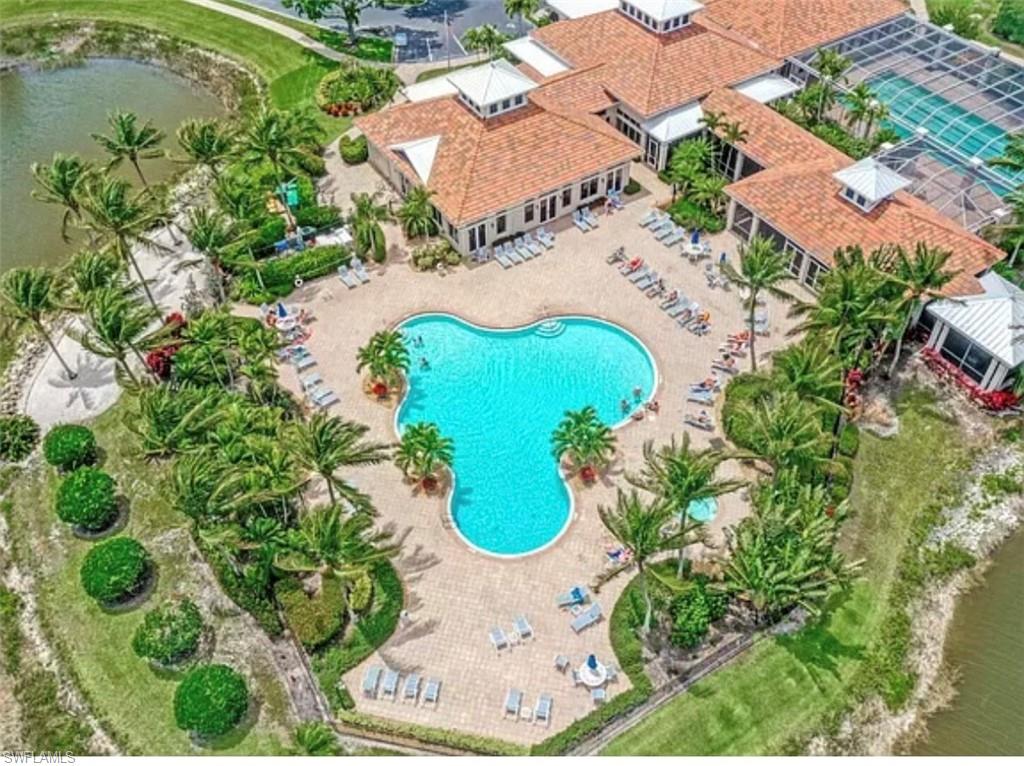 Bird's eye view of a nearby body of water and a pool area