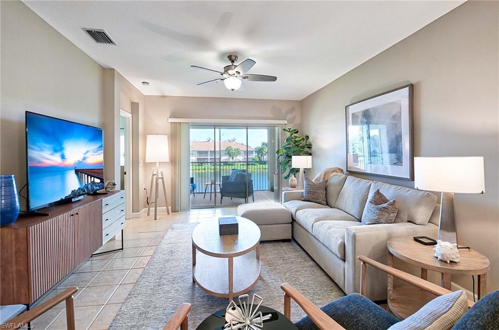 Living room with ceiling fan and light tile patterned floors