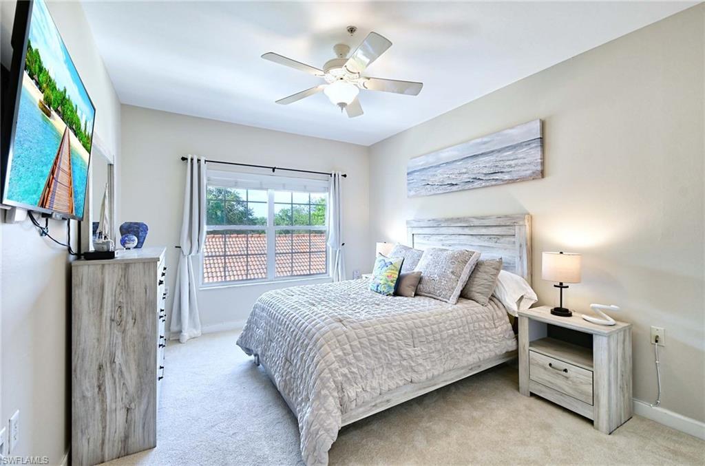 Bedroom with light colored carpet and ceiling fan
