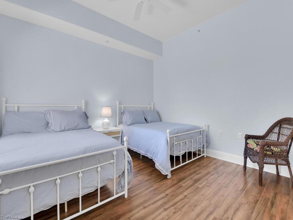 Bedroom with baseboards, ceiling fan, and wood finished floors
