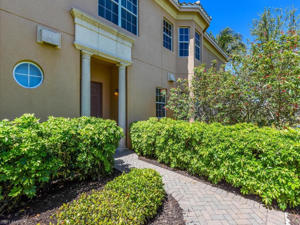 View of exterior entry with stucco siding