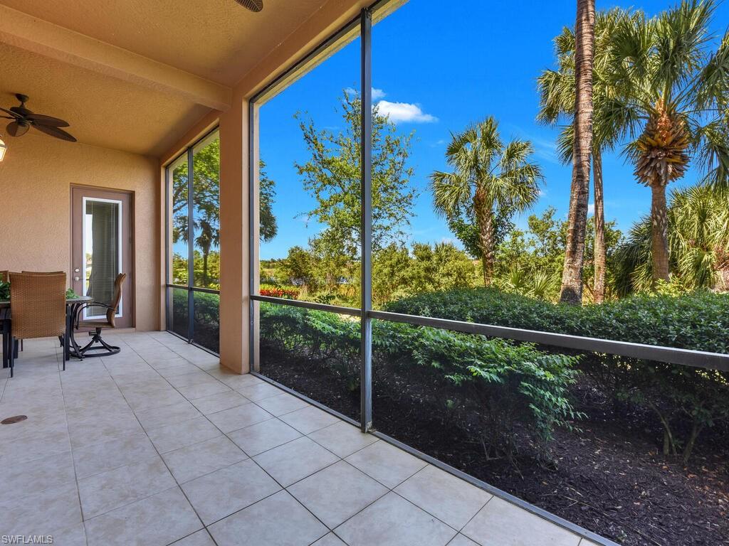 Unfurnished sunroom with tile patterned floors and beamed ceiling