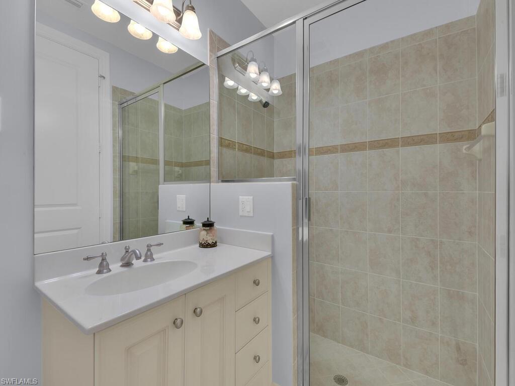 Bathroom featuring a shower stall and vanity