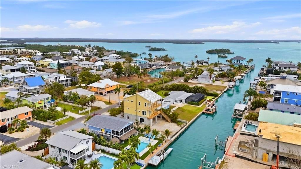 Aerial view of residential area featuring a nearby body of water - Virtually Edited Image