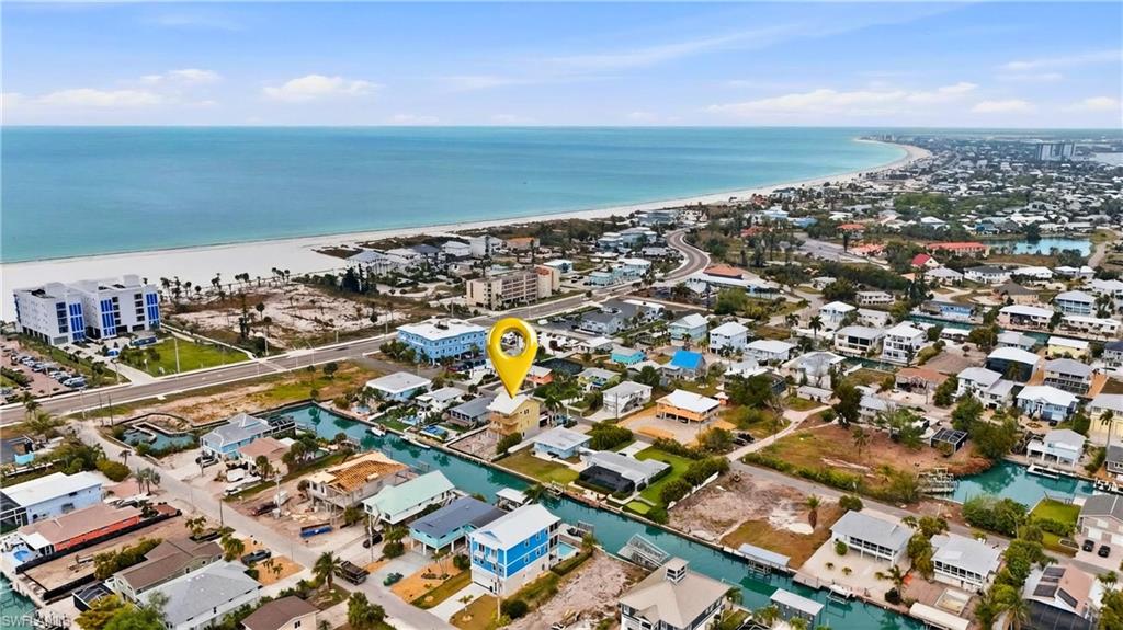 Aerial perspective of suburban area with a nearby body of water  - Virtually Edited Image