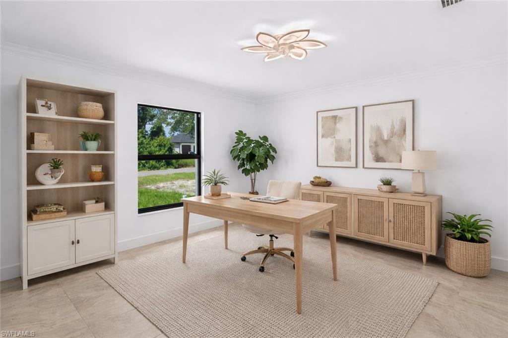 Office space with baseboards and crown molding
