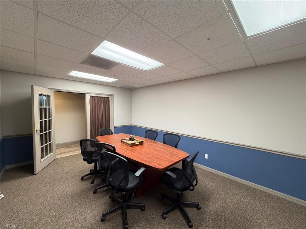 Office space featuring carpet floors and a drop ceiling