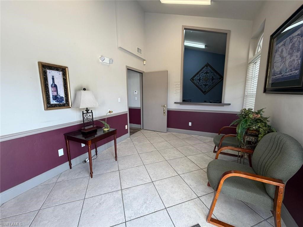 Hallway featuring light tile patterned flooring and baseboards